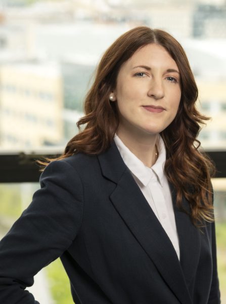 A headshot of Dr. Chelsea Blackburn Cohen, who is posing in front of window.