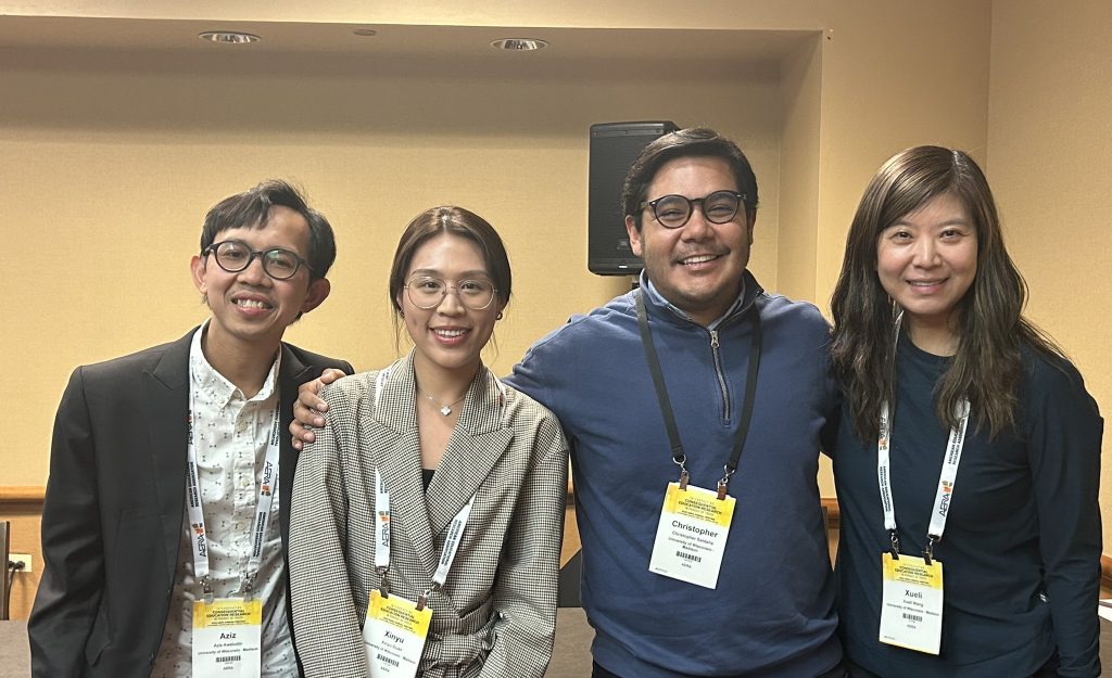 ELPA students and faculty smiling for a picture at the annual AERA conference. From left to right: ELPA students Aziz Awaludin and Xinyu Guan; ELPA faculty Chris Saldaña and Xueli Wang