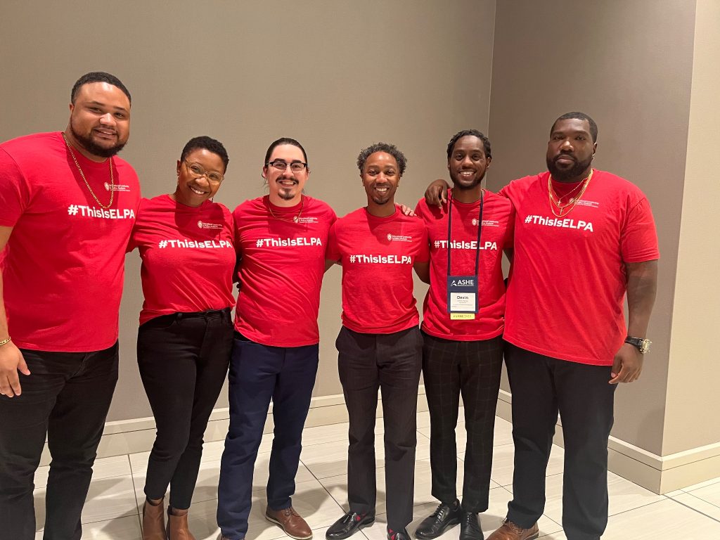 Dr. Brian Burt and ELPA students from the Wei Lab smiling for a picture in matching #ThisIsELPA red shirts at the annual ASHE conference in fall 2023. From Left to Right: Joshua Wallace, Tiaira Porter-Beall, Mark Moralez, Dr. Brian Burt, Kevin Henry, and Blayne Stone