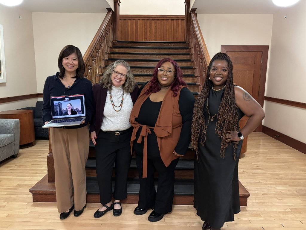 ELPA student Janella Benson poses for a picture with her dissertation committee (Xueli Wang, Rachelle Winkle-Wagner, Aireale Rodgers) after successfully defending her dissertation to complete her PhD in Higher Education. The group stands at the bottom of the stairs on the lower level of the Education Building.