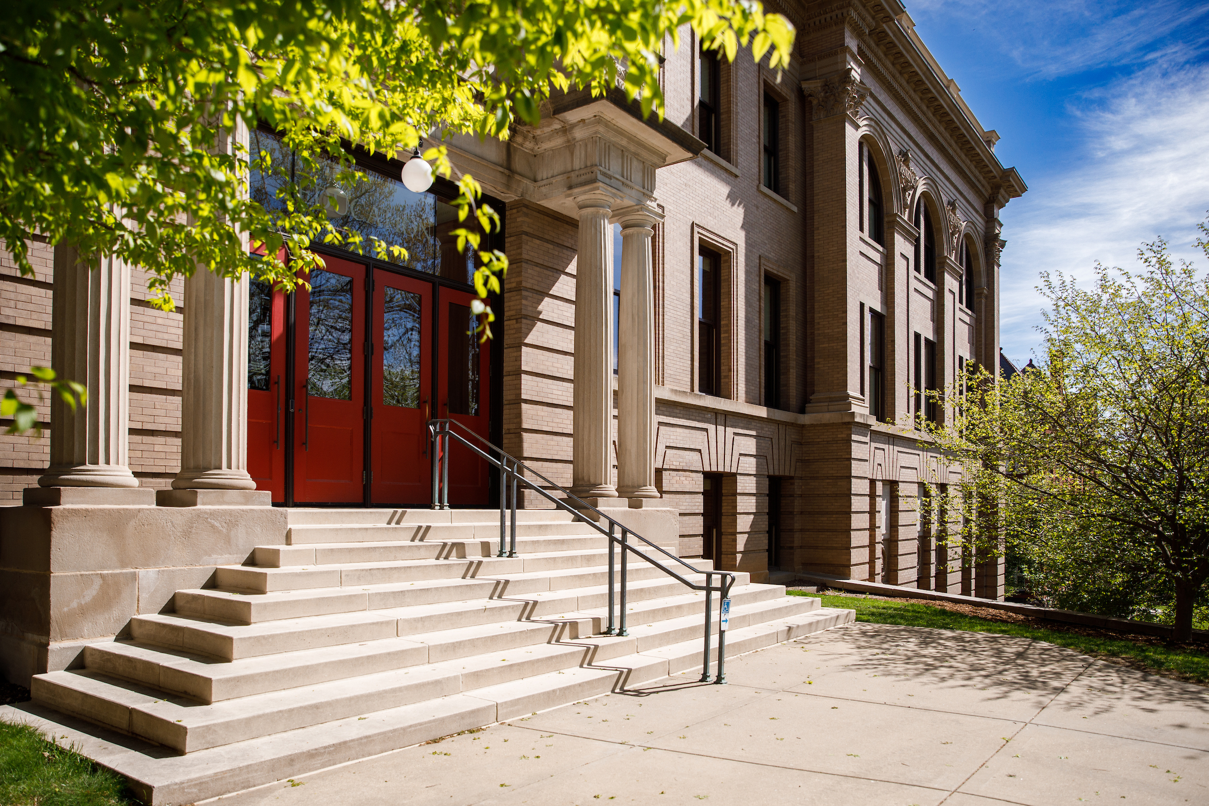 The red doors of the Education Building from a side angle on a sunny day.