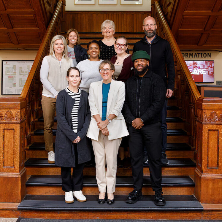 A group photos of the ELPA department K-12 Leadership, Policy, and Sports Leadership faculty taken September 2026. The group is standing on the stairs of the School of Education Building.